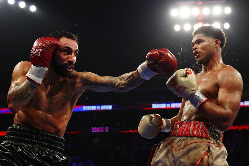 NEWARK, NEW JERSEY - JULY 06: Shakur Stevenson (gold gloves) exchanges punches with Artem Harutyunyan of Germany (red gloves) during their WBC lightweight world title fight at Prudential Center on July 6, 2024 in Newark, New Jersey. (Photo by Sarah Stier/Getty Images)