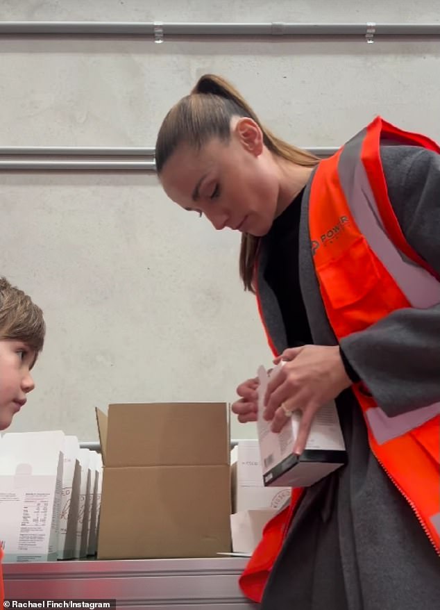 The brothers were kitted out in high-visibility gear as they carefully stacked the supplies into cardboard boxes, while their mother supervised.