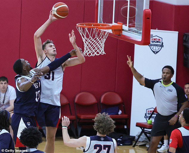 Cooper Flagg (31) dunks a ball over Miami Heat defender and star Bam Adebayo (13)