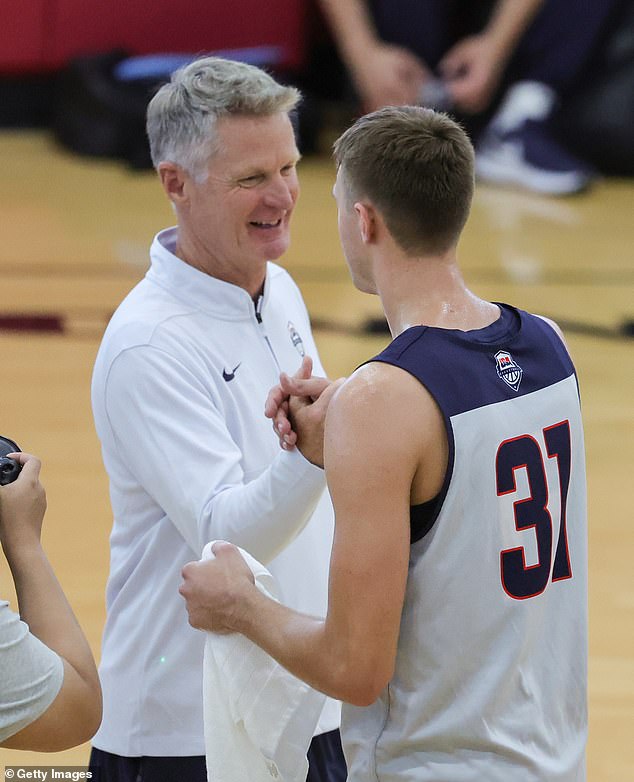 Flagg (31) shakes hands with USA Basketball head coach Steve Kerr after practice.