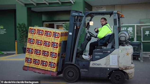 Pallets of Ricciardo brand red wine are transported on forklifts in the shopping area.