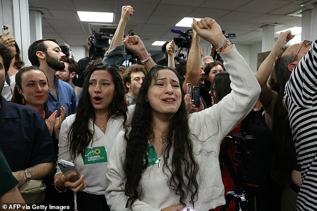 Supporters of the green party Les Ecologistes-EELV celebrate the first results of the second round of France's legislative elections during the party's election night event in Paris on Sunday.