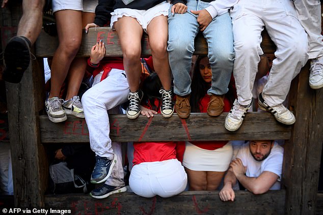 The revellers wait at the fence for the start of the first "confinement"