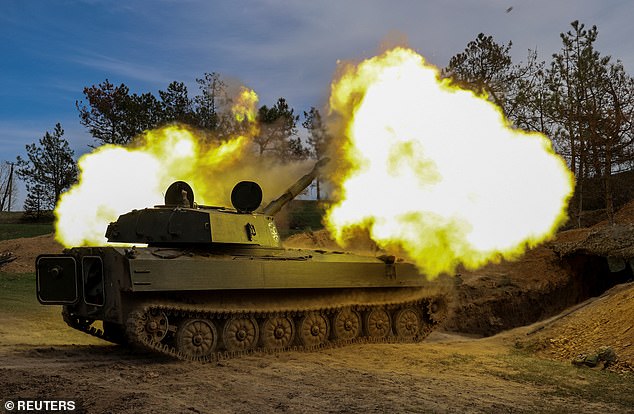 Ukrainian servicemen from the 37th Marine Brigade fire a 2S1 Gvozdika self-propelled howitzer towards Russian troops