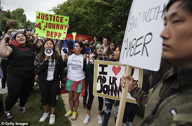 Supporters of Johnny Depp argue with a supporter of Amber Heard outside a Fairfax County courthouse on May 27, 2022