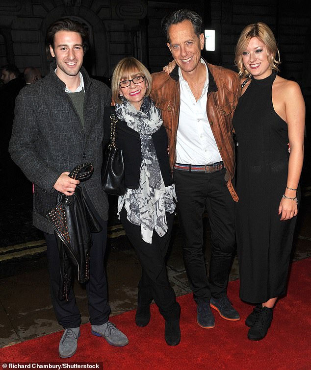 Grant pictured with his late wife Joan, daughter Olivia and stepson Tom in October 2013