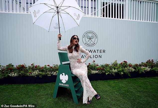 She added an edgy vibe to her look with a pair of chunky black heels and sunglasses, while incorporating a pop of color with a swipe of red lipstick.