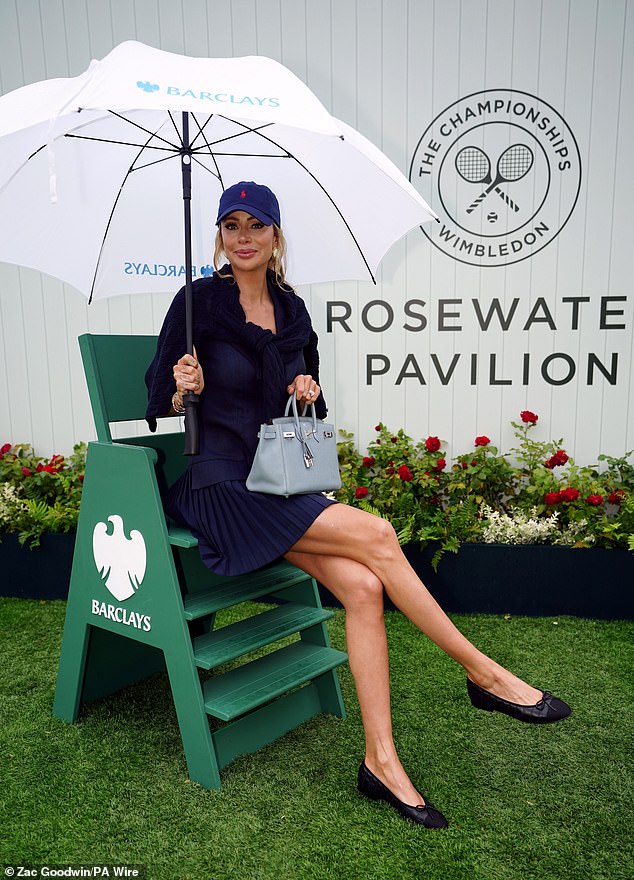 Olivia Attwood went for a preppy chic look in a navy tennis dress, which she wore with a sweater over her arms and a Ralph Lauren cap.