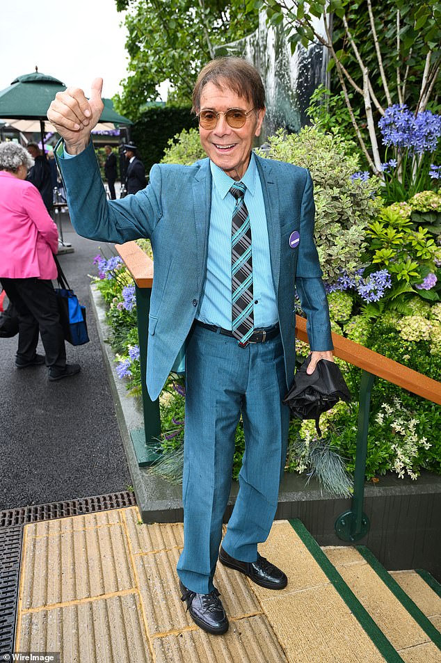 Cliff Richard gave a thumbs-up as he arrived in a teal suit.