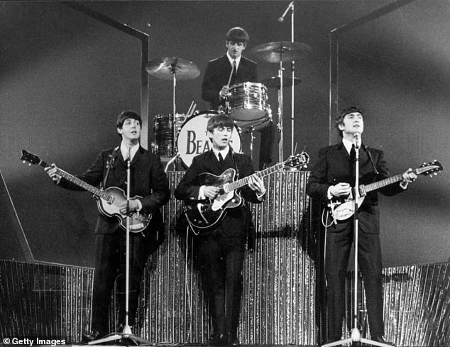 The Beatles on stage at the London Palladium during a performance in front of 2,000 screaming fans