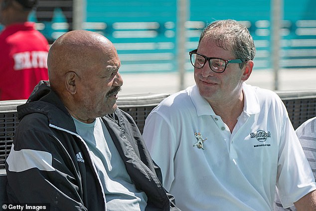 The quarterback finished his NFL career with one season with the Dolphins. He is pictured here with Hall of Fame running back Jim Brown at a Miami game in 2016.