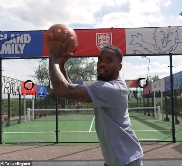 Toney takes a no-look basketball shot to mimic his no-look penalty against Switzerland