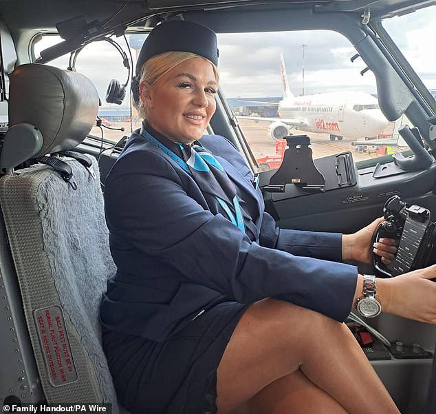 Mrs. Warner was a flight attendant and is shown here posing in the cockpit of an airplane.