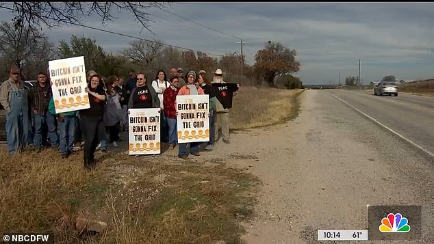 Pictured above are local residents during a protest over the Bitcoin mine. Local officials say they can only fine the mine for noise pollution.