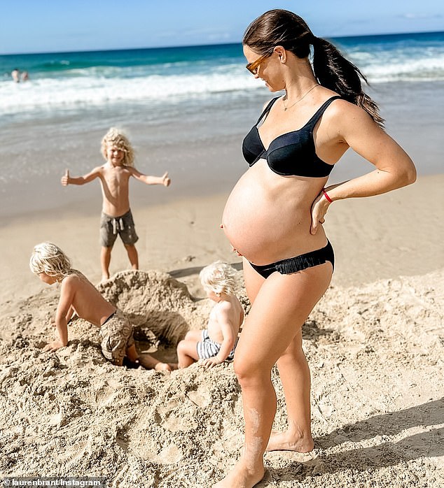 Hall's wife Lauren (pictured with their three children) is due to give birth to their fourth child the day after his fight with Scott.