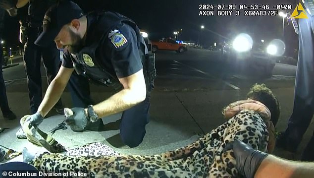 The group of officers arresting Pancake laugh as they find the hamsters in the pockets of his unusual outfit.