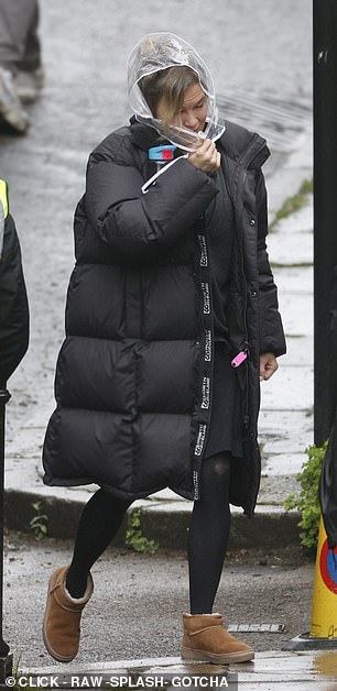 Renee was forced to wear a protective hair hood and a black padded coat as she braved the bad weather on set in Hampstead.