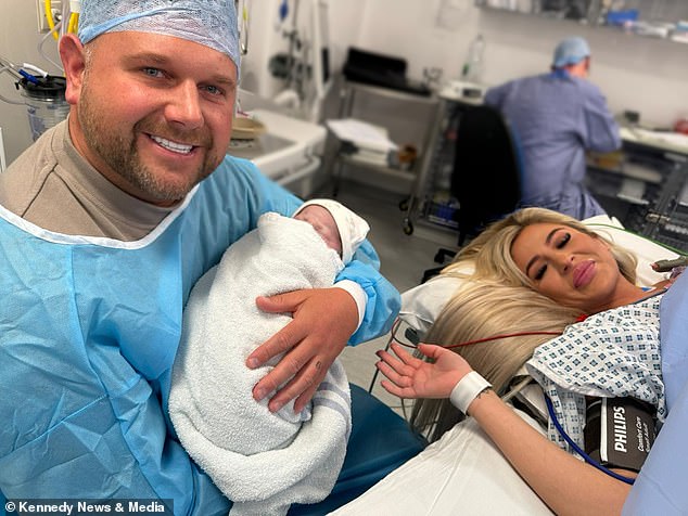 Bromley smiled for a photo with her newborn, Cove, and her proud father, her partner Mark Cottrell.