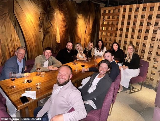 McIlroy (second back left) and Erica Stoll (fourth back right) enjoyed a night out with their Ryder Cup teammates and partners in London on Sunday night.