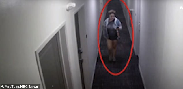 Miller is seen in the hallway of the apartment building.