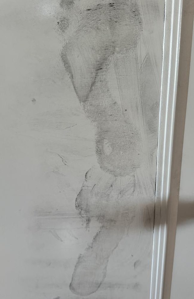 A photograph of the couple's battered bedroom door shows it was heavily marked with multiple footprints (pictured)