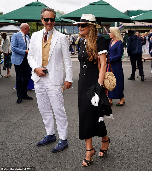 Meanwhile, Jemima, 50, cut a chic figure in a black midi dress which featured a structured white collar, short sleeves and a black belt with a silver diamond buckle.