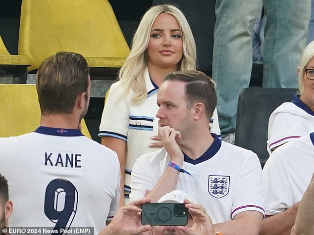 Wearing an England shirt paired with a glamorous white and blue blazer and skirt set, Megan was more than ready to support her goalkeeper husband.