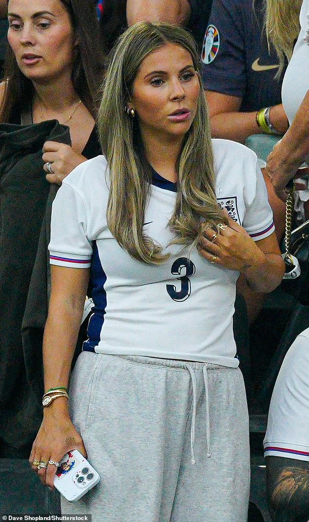 Luke Shaw's girlfriend Anouska Santos wore tracksuit bottoms and her own football shirt before the match.