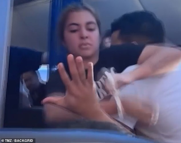 The video recorded by another traveler began after the crew had zip-tied her wrists and she was struggling with three of them.