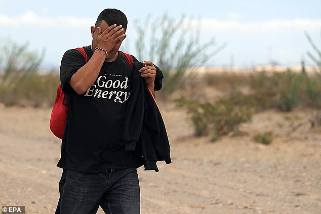 A migrant walks through the Chihuahua desert in Ciudad Juarez, Mexico