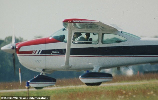 JFK Jr in the cockpit of his small plane with Carolyn