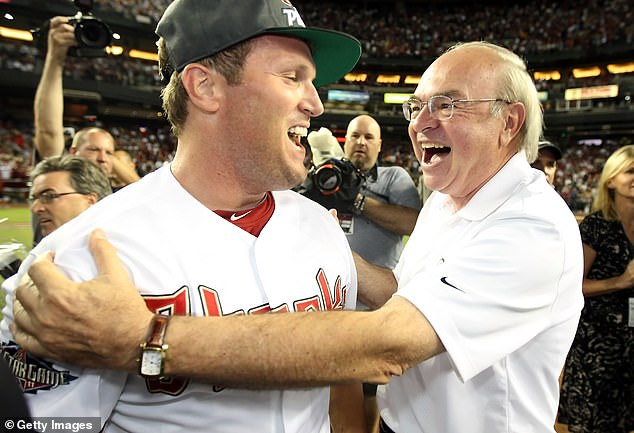 Burroughs, pictured with Arizona Diamondbacks owner Ken Kendrick after winning the NL West in 2011, appeared in 528 major league games.