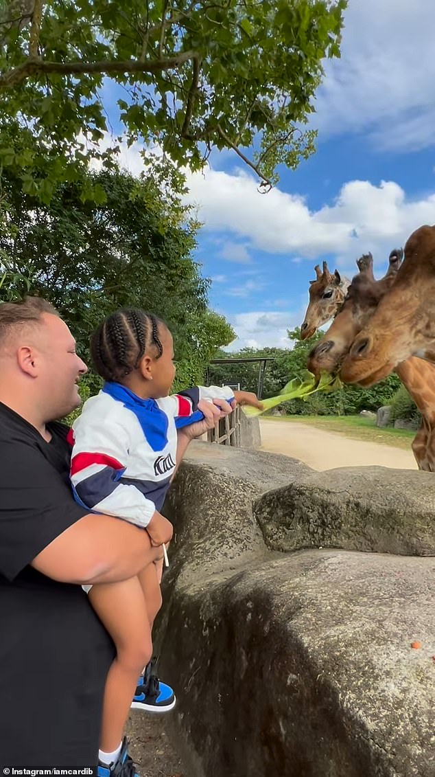 Cardi captured her son feeding the giraffes at the Paris zoo