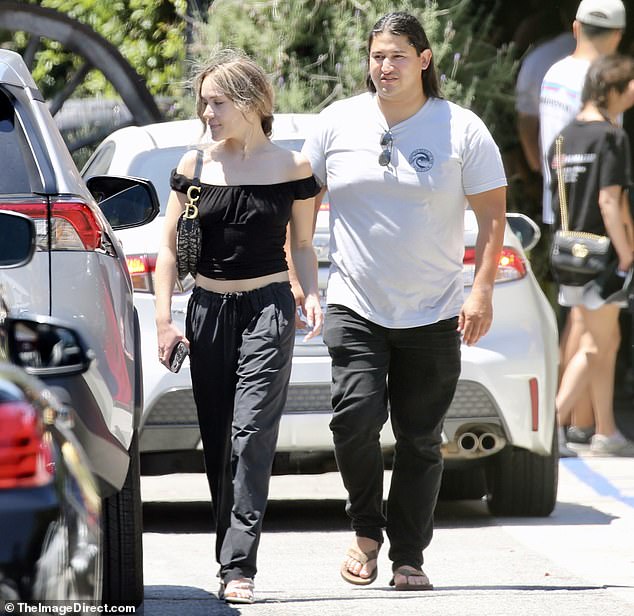 The couple seemed unconcerned by the attention as they strolled down the street together.