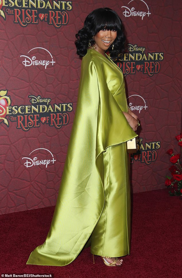 The 45-year-old singer wore a striking lime green satin cape dress to the star-studded event.