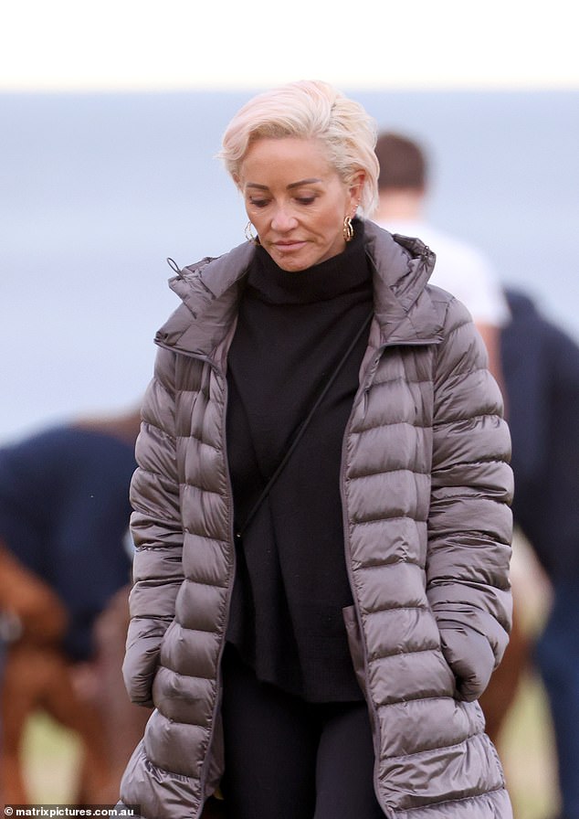 The travel journalist cut a casual figure in flared black leggings, a turtleneck sweater and a grey quilted jacket.