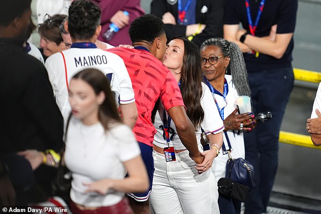 Watkins was greeted as a hero by friends and family of the England players after the match and shared a kiss with his girlfriend Ellie Alderson, as his mother Nicola (right) looked on.