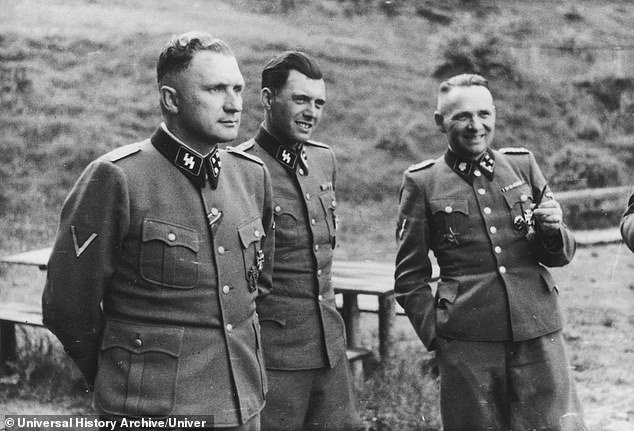 Mengele, nicknamed the Angel of Death because he selected those to be killed in the gas chambers, carried out a series of cruel tests on twins during the war, including stitching them together to create conjoined twins. Pictured, from left: SS officers Richard Baer, ​​Dr Josef Mengele and Rudolf Hoess