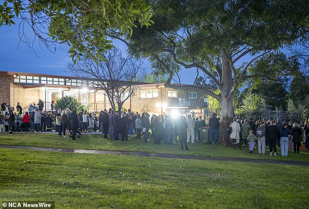 Members of the Lalor Park community gather in Chifley Park on Thursday for a vigil for the three young children who died in a house fire on Sunday.