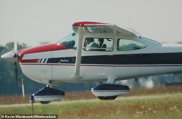 John F. Kennedy Jr. seated in the cockpit with his wife, Carolyn, in 1998 (he is pictured on a plane that same year)