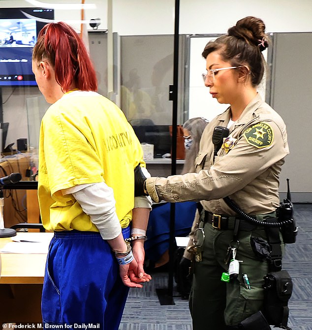 Reynolds, looking disheveled in a pair of blue sweatpants and a bright yellow T-shirt provided by the Los Angeles County jail, did not speak during the brief appearance and looked down at her feet as she was led into court.