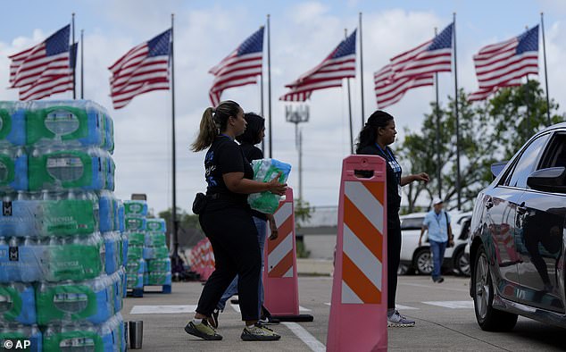 Lakewood Church staff distribute water and operate a cooling station in Houston