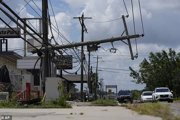 Traffic is diverted toward a downed power line in Houston on Tuesday