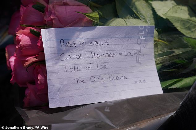 Flowers left outside the house where the bodies of Carole, Hannah and Louise Hunt were found on Tuesday