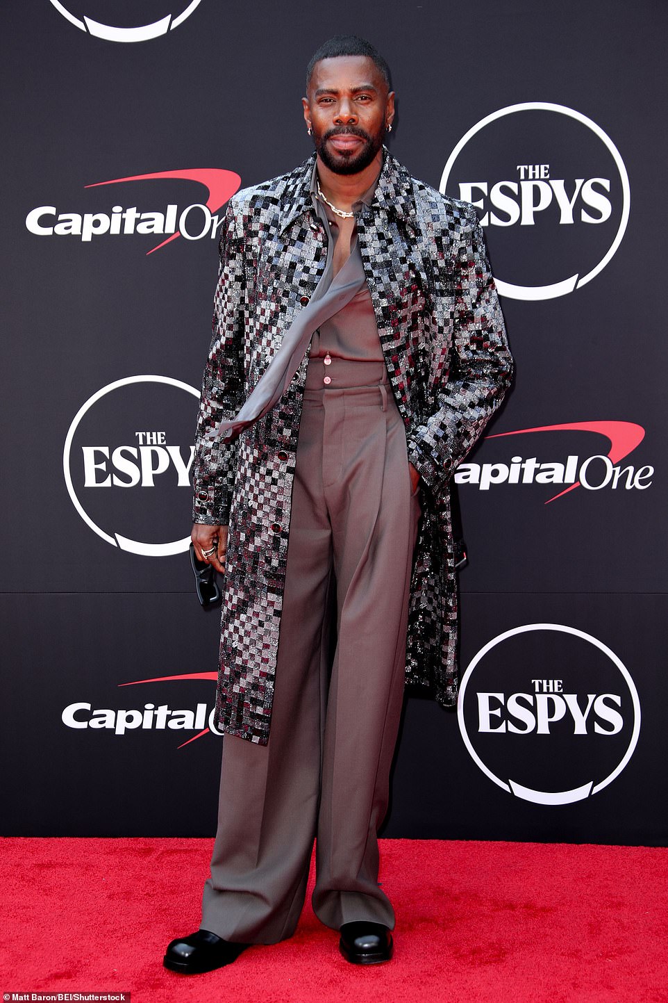 Colman Domingo, 54, showed off his laid-back style in vintage-inspired high-waisted Frey trousers, a matching grey silk shirt and a metallic coat.