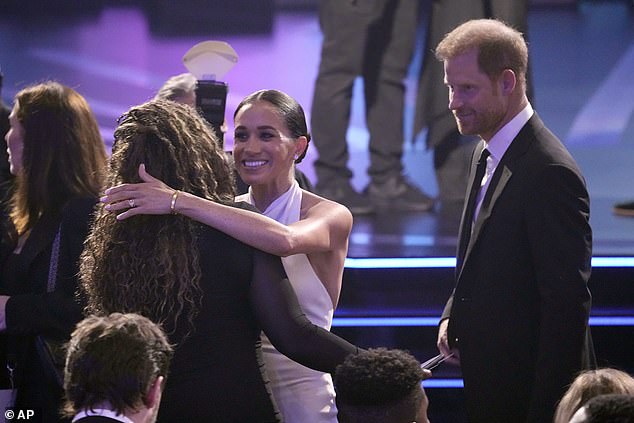 Before the ceremony began, Harry and Meghan were seen catching up with friends in the audience, with the Duchess leaning over to give an aide a big hug.