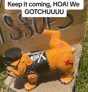 A toy bulldog in a cocked bondage suit now graces the lawn.