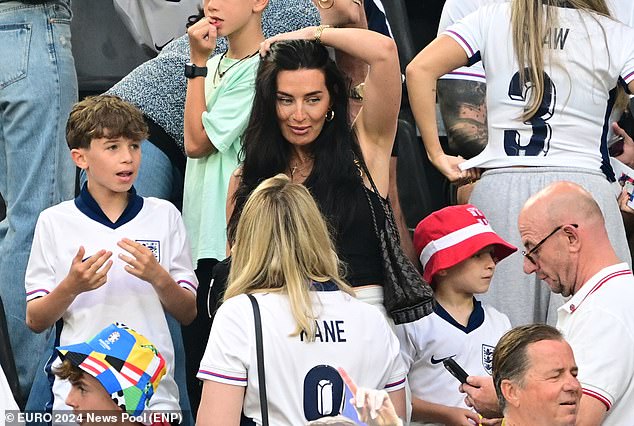 Annie tried to smile as she chatted to fellow WAG and wife of Harry Kane, Katie Goodland.