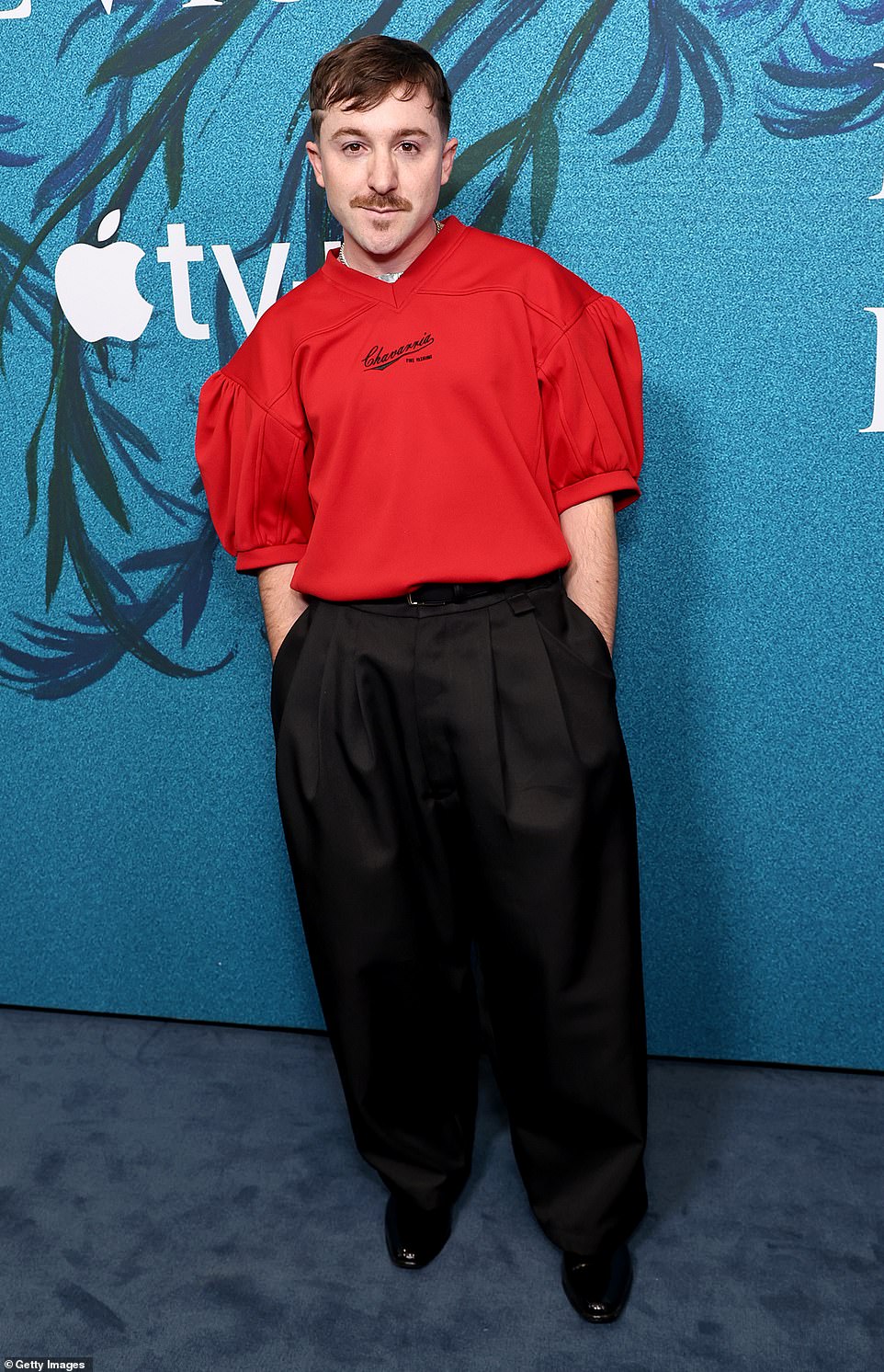 Production designer JC Molina made a fashion statement in a red jumper, which was tucked into his pleated, wide-leg black pants.