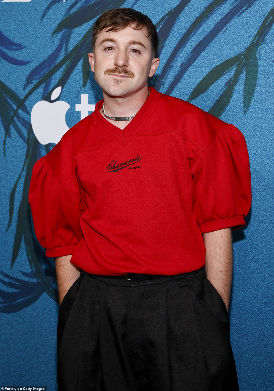 He added some shiny black dress shoes and walked the red carpet with his brown hair cut above his ears while also sporting a mustache.